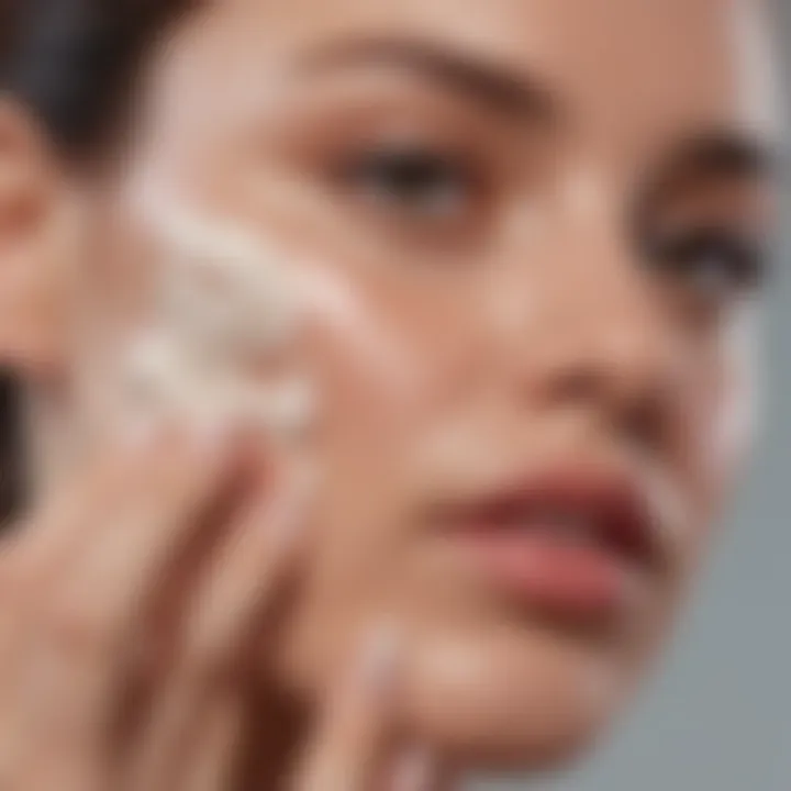 Close-up of a hand applying cream to the face for hydration