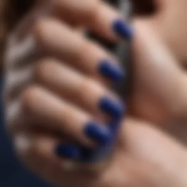 Close-up of a hand showcasing a deep cobalt blue shade from OPI.