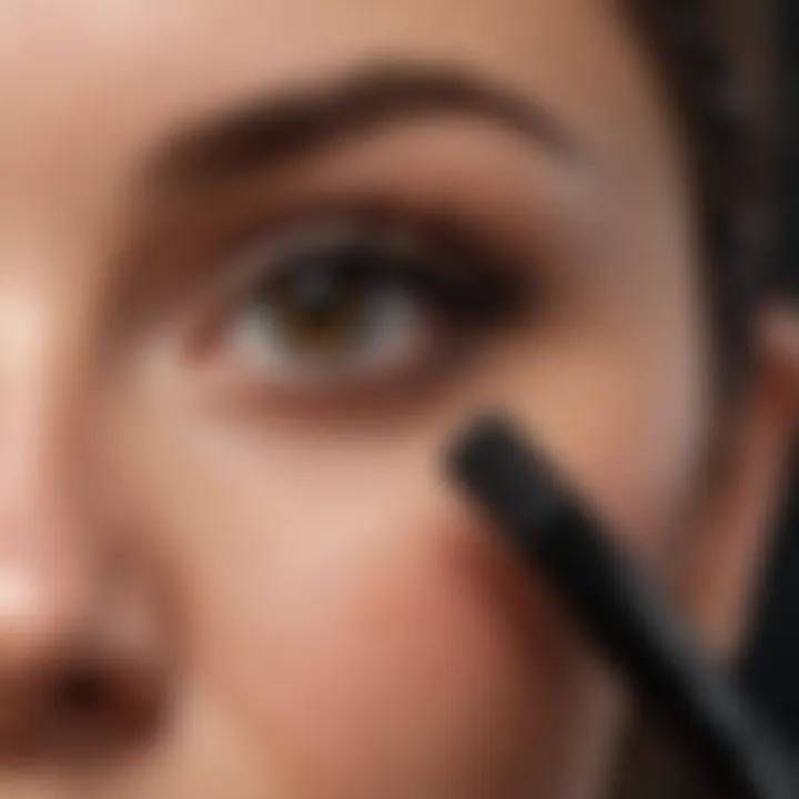 A close-up of a mascara brush loaded with rich black formula