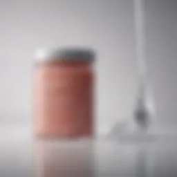 A close-up of a collagen powder jar beside a glass of water with a scoop