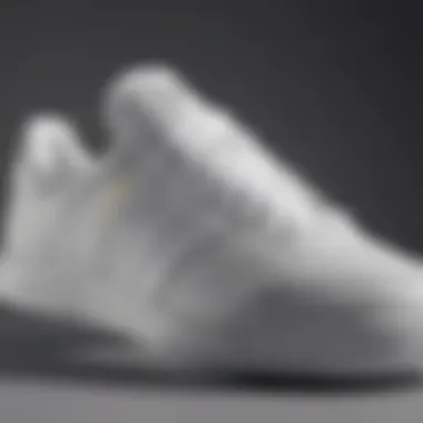 Close-up of white adidas tennis shoes showcasing design details