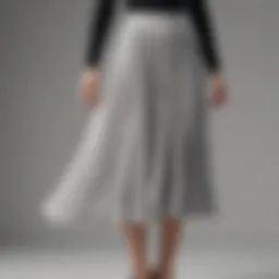 Elegant pleated midi skirt showcasing its flowing design and fabric texture