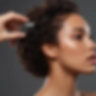 A close-up of a hand applying a creamy moisturizer to textured hair.