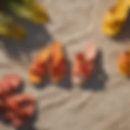 Brightly colored sandals laid out on a beach towel